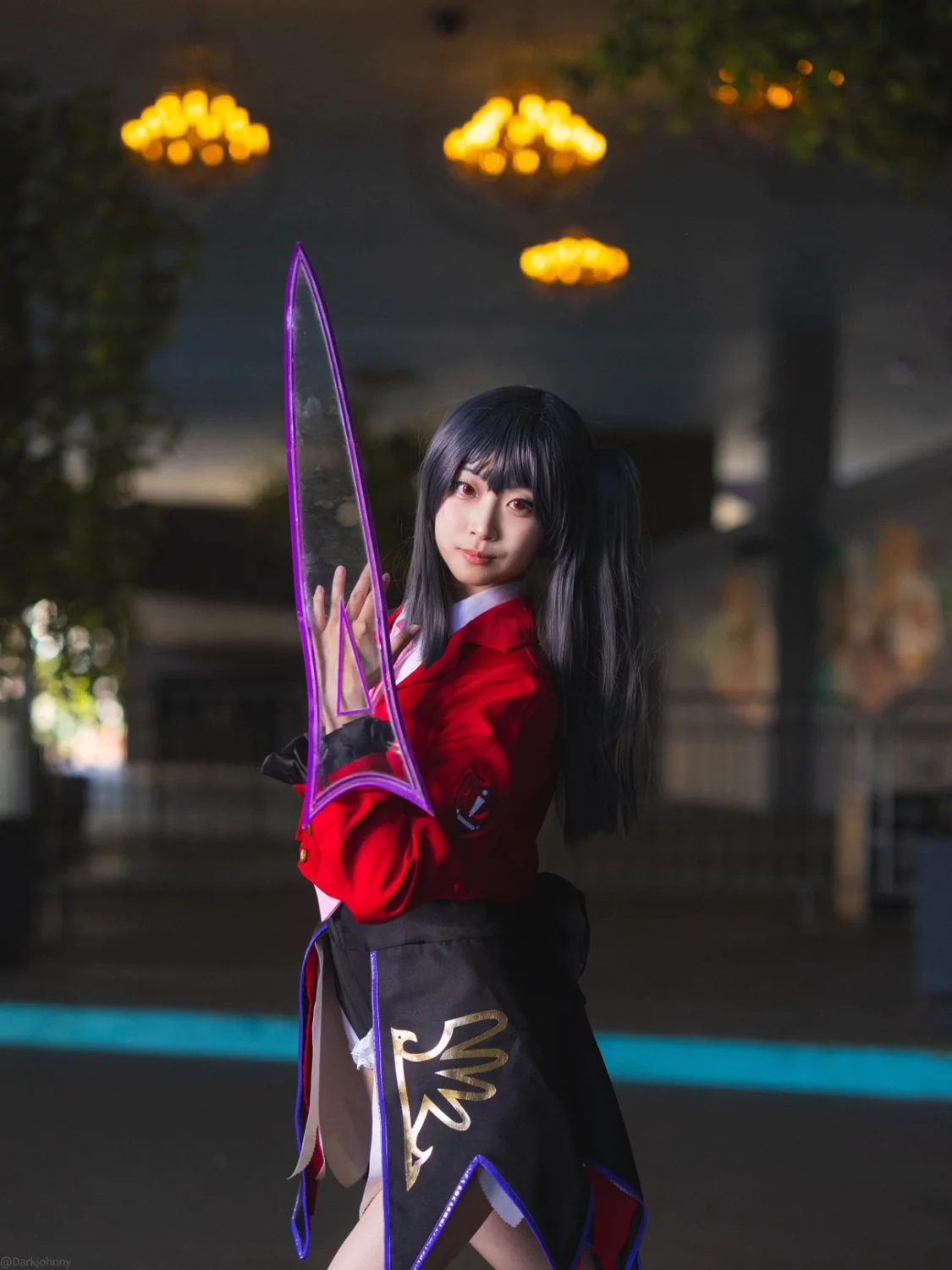 Cosplayer holding a custom transparent purple prop